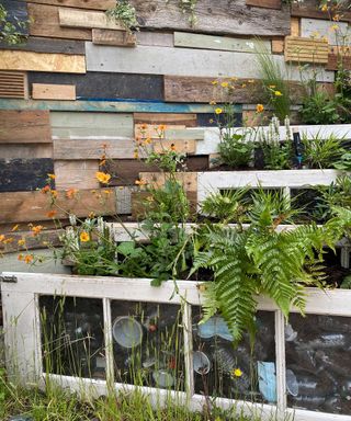 wall and raised beds made from recycled materials at gardena stand at chelsea flower show 2022