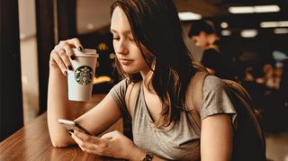 Girl with coffee and smartphone