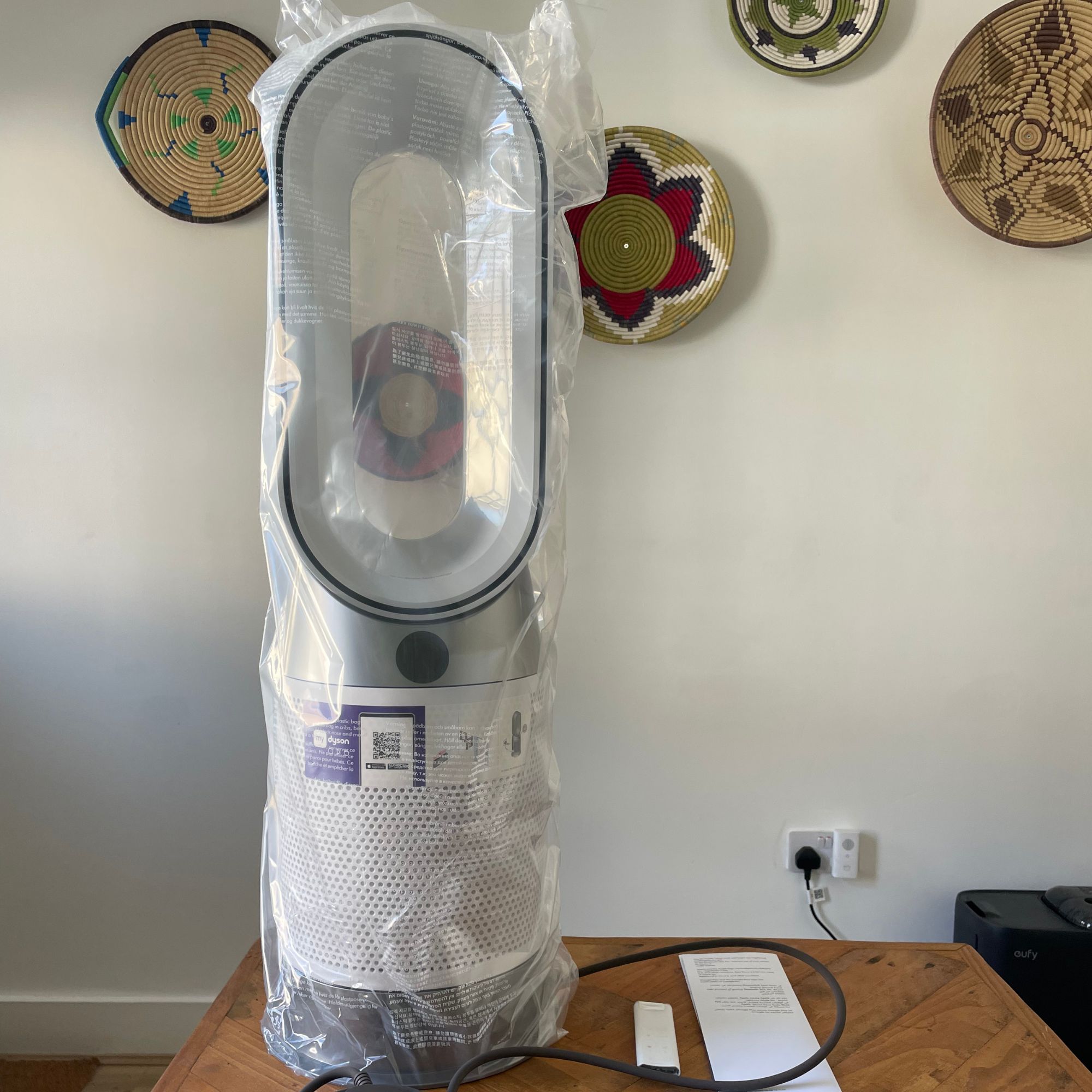 Dyson Purifier Hot+Cool HP1 Purifying Fan Heater wrapped in plastic, sitting on a wooden table