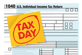 The word TAX DAY written on a yellow note on form 1040