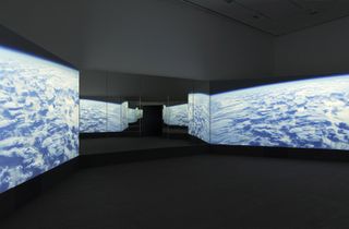 Installation view of ‘Doug Aitken: New Era’ at 303 Gallery, New York, video installation with three channels of video (colour, sound), three projections, freestanding room, PVC projection screens, mirrors