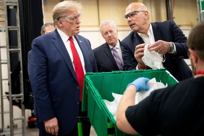 Donald Trump visits a mask factory.