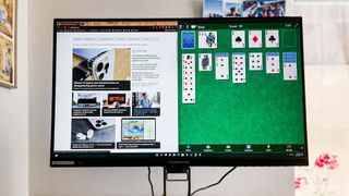 Acer Predator XB323QK NV gaming monitor w/ website and solitaire game onscreen