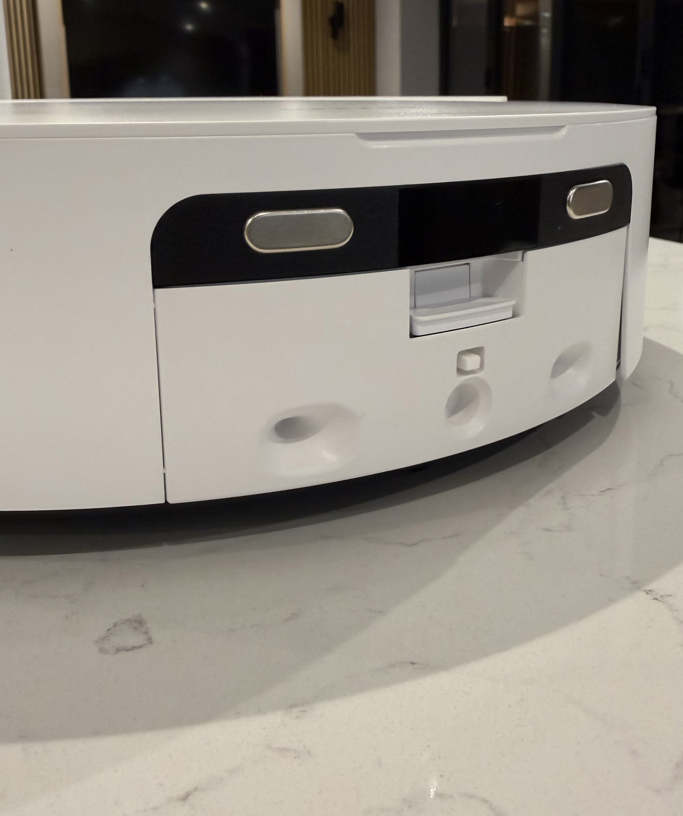 Rear view of the Dreame Aqua10 Ultra Roller showing charging contacts, water ports, and docking connectors