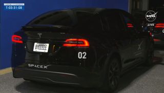 A black Tesla with the word Byeeeee on its license plate for Crew-7 astronauts