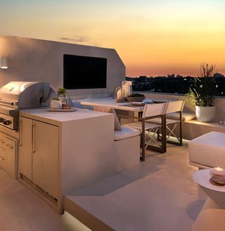 an outdoor kitchen made from microcement at night