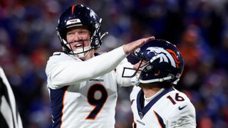 Riley Dixon #9 and Wil Lutz #16 of the Denver Broncos celebrate ahead of the Broncos vs Texans game