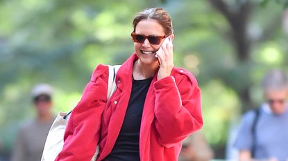 Katie Holmes wears a red barn jacket trend with ballet flats while out in new york city