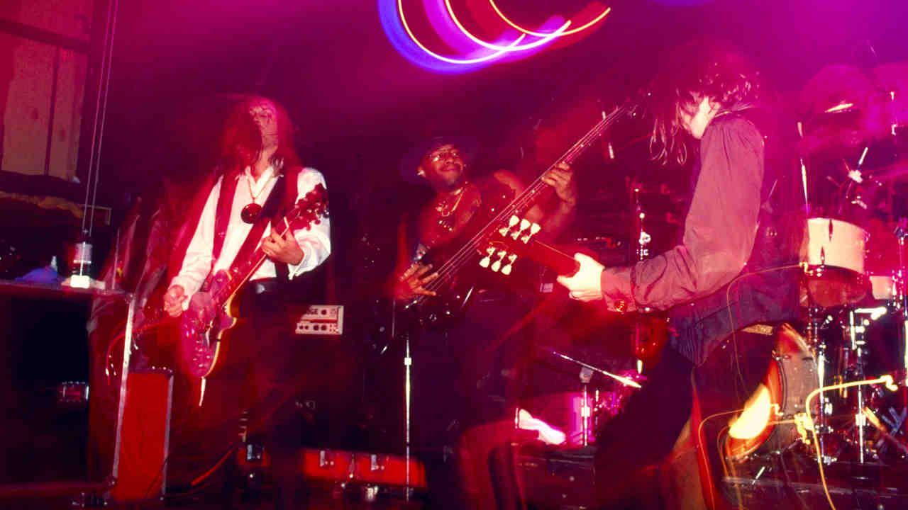 Urge Overkill performing onstage in 1993