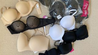 a selection of the best strapless bras tested by woman&home, laid out on a beige carpet