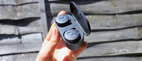 a hand holding the nuratrue wireless earbuds in their charging case