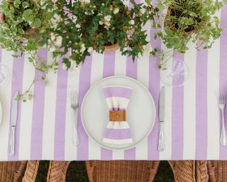 Image of table laid with purple gingham napkins and matching table cloth