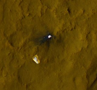 This color view of the parachute and back shell that helped deliver NASA's Mars rover Curiosity to the Red Planet was taken by NASA's Mars Reconnaissance Orbiter. Image released Sept. 6, 2012.