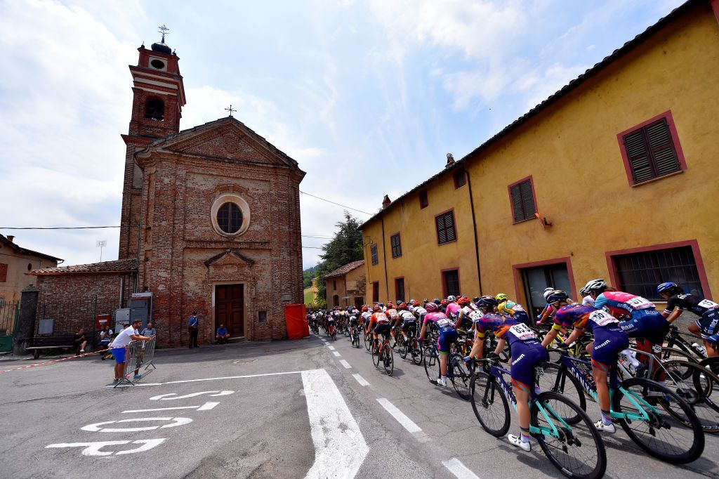 PRATO NEVOSO ITALY JULY 03 Alexis Ryan of United States Mikayla Harvey of New Zealand and Canyon SRAM Racing Team The Peloton passing through Pianfei Village area during the 32nd Giro dItalia Internazionale Femminile 2021 Stage 2 a 1001km stage from Boves to Prato Nevoso Colle del Prel 1607m Fans Public Church Landscape GiroDonne UCIWWT on July 03 2021 in Prato Nevoso Italy Photo by Luc ClaessenGetty Images