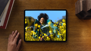 Apple iPad Air (6th Generation) displaying a colourful image of a man in a field