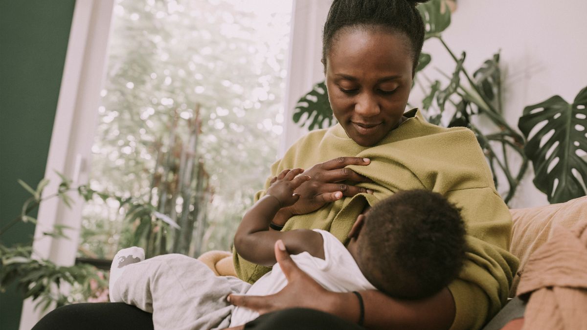 woman breast feeding her child