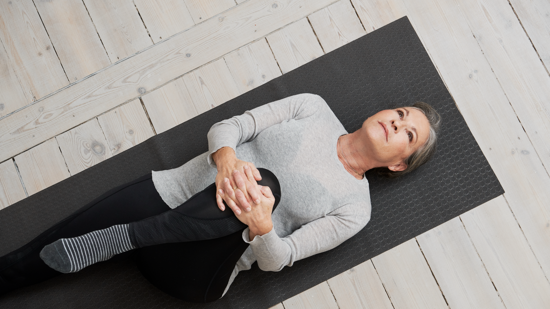 Woman stretching on a yoga mat