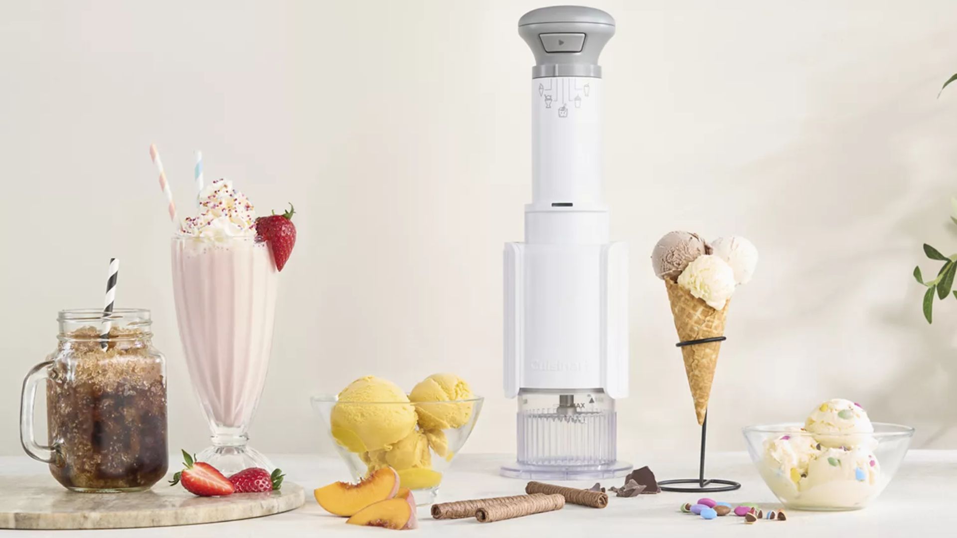 Cuisinart Freeze Wand ice-cream maker on a countertop surrounded by different frozen treats