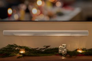 Sonos ArcUltra sound bar mounted below television with holiday decorations