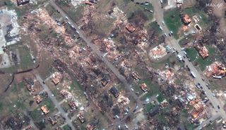 a satellite photo showing widespread destruction of a residential area following a tornado