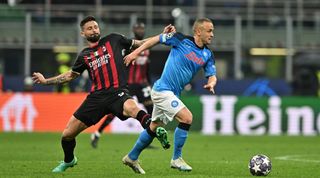 Olivier Giroud of AC Milan attempts to dispossess Stanislav Lobotka of Napoli during the UEFA Champions League quarter-final first leg match between AC Milan and Napoli at the San Siro on April 12, 2023 in Milan, Italy.