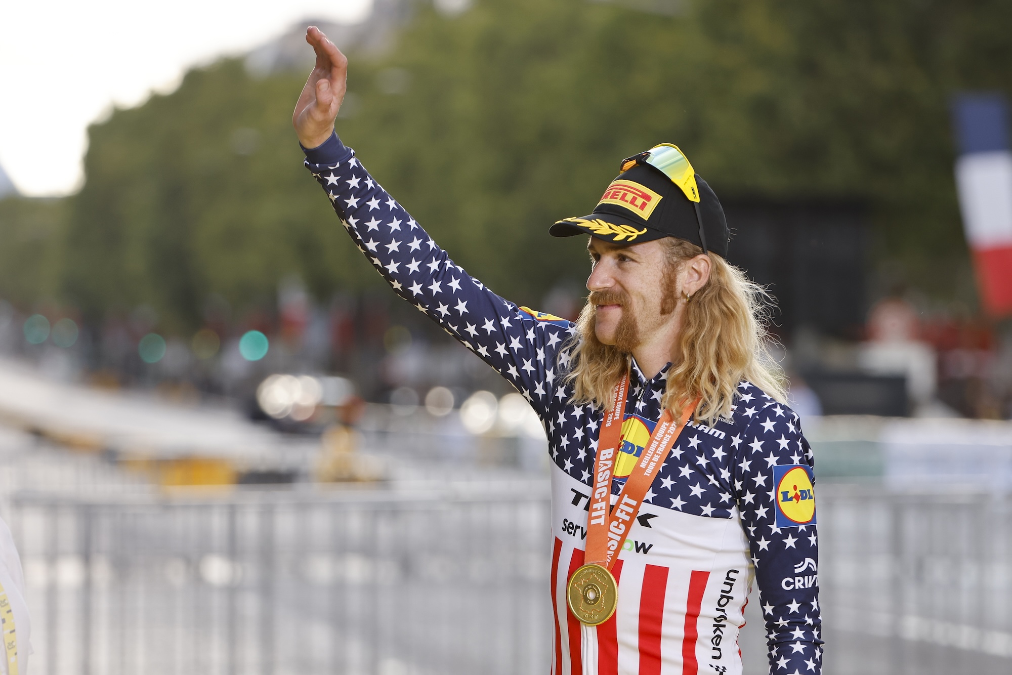 Quinn Simmons of USA celebrates the 'best team' trophy for Lidl-Trek during the podium ceremony following Stage 21 of the 2026 Tour de France