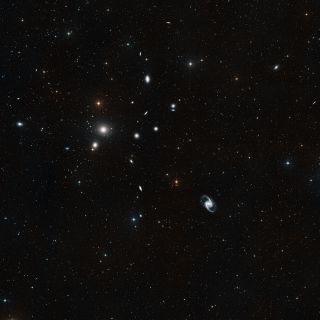 This image shows a wide-field view of a region of space including the Fornax galaxy cluster, which can be found in the southern constellation Fornax (The Furnace).