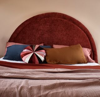 A bedroom with a large, circular headboard