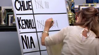 Jill marking a tally next to Kendall's name on the white board