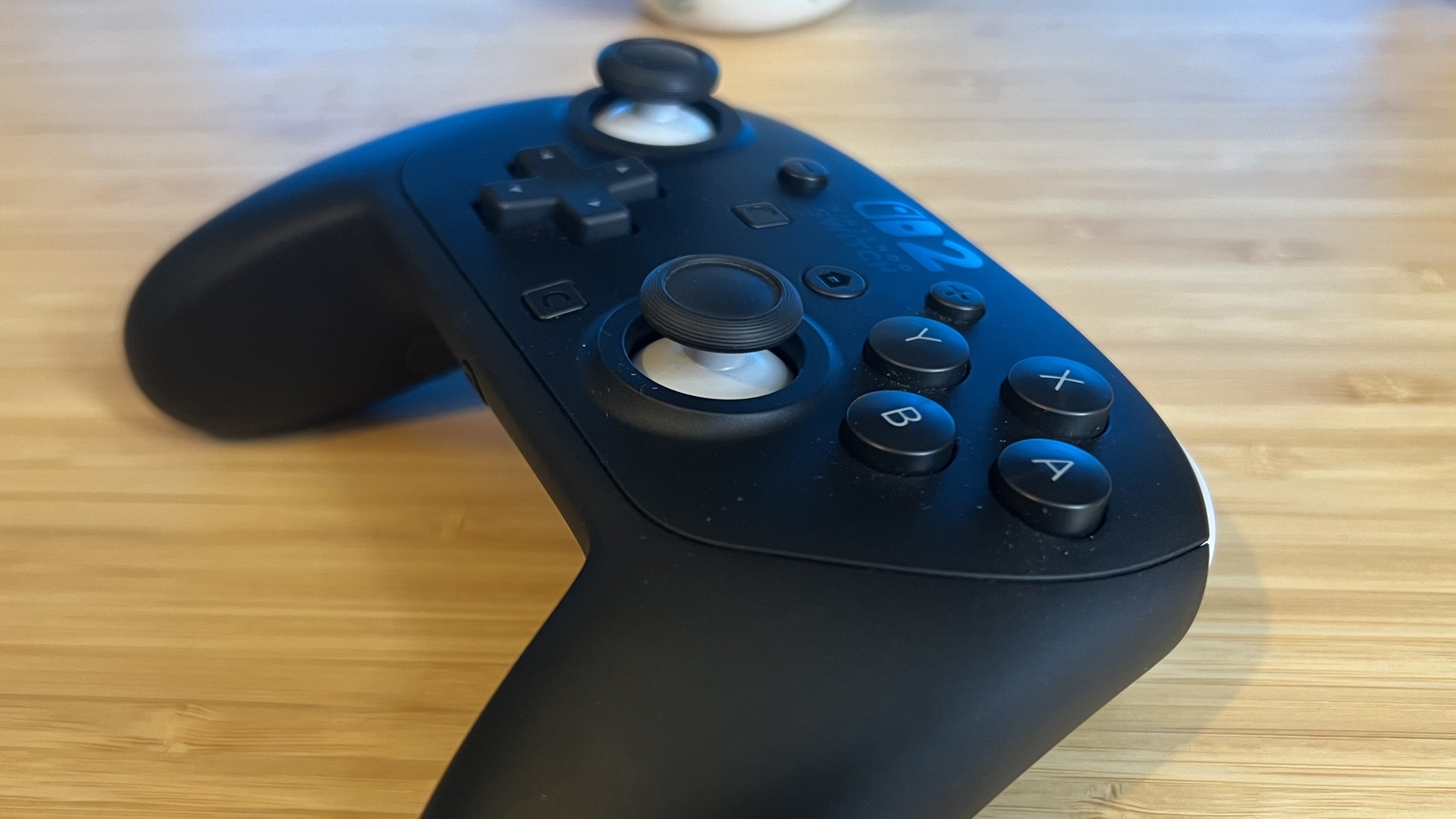 Nintendo Switch 2 Pro Controller on a wooden desk