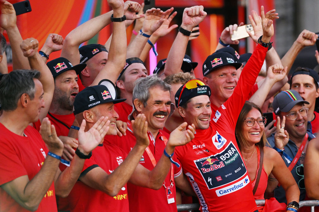MADRID, SPAIN - SEPTEMBER 08: (L-R) Team Manager Ralph Denk, final overall winner and Primoz Roglic of Slovenia - Red Leader Jersey and Team Red Bull Bora - hansgrohe celebrates at podium as Red Leader Jersey winner during the La Vuelta - 79th Tour of Spain 2024, Stage 21 a 24.6km individual time trial stage from Madrid to Madrid / #UCIWT / on September 08, 2024 in Madrid, Spain. (Photo by Dario Belingheri/Getty Images)