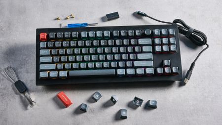 Keychron V3 Ultra 8K photographed on a grey table top in front of a blue background