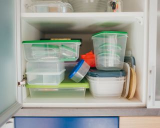 cupboard of plastic food storage containers
