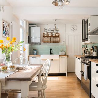 kitchen with wooden flooring white cabinet and wooden worktop