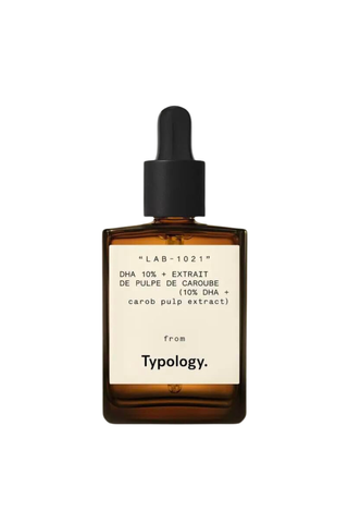 A bottle of Typology Tanning Serum against a white background.
