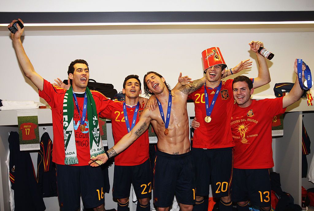 Sergio Busquets, Jesus Navas, Sergio Ramos, Javier Martinez and Juan Manuel Mata of Spain pose with the trophy in the Spanish dressing room after they won the 2010 FIFA World Cup at Soccer City Stadium on July 11, 2010 in Johannesburg, South Africa