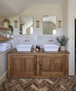 wooden vanity unit with two white sinks in traditional bathroom