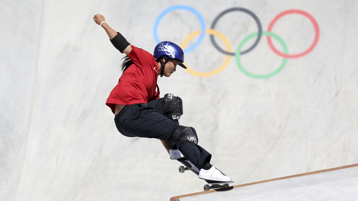 Japan&#039;s Sakura Yosozumi on the lip of a ramp, in black trousers and a red shirt, at the Olympic Games.