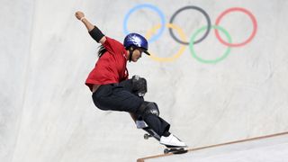 Japan's Sakura Yosozumi on the lip of a ramp, in black trousers and a red shirt, at the Olympic Games.