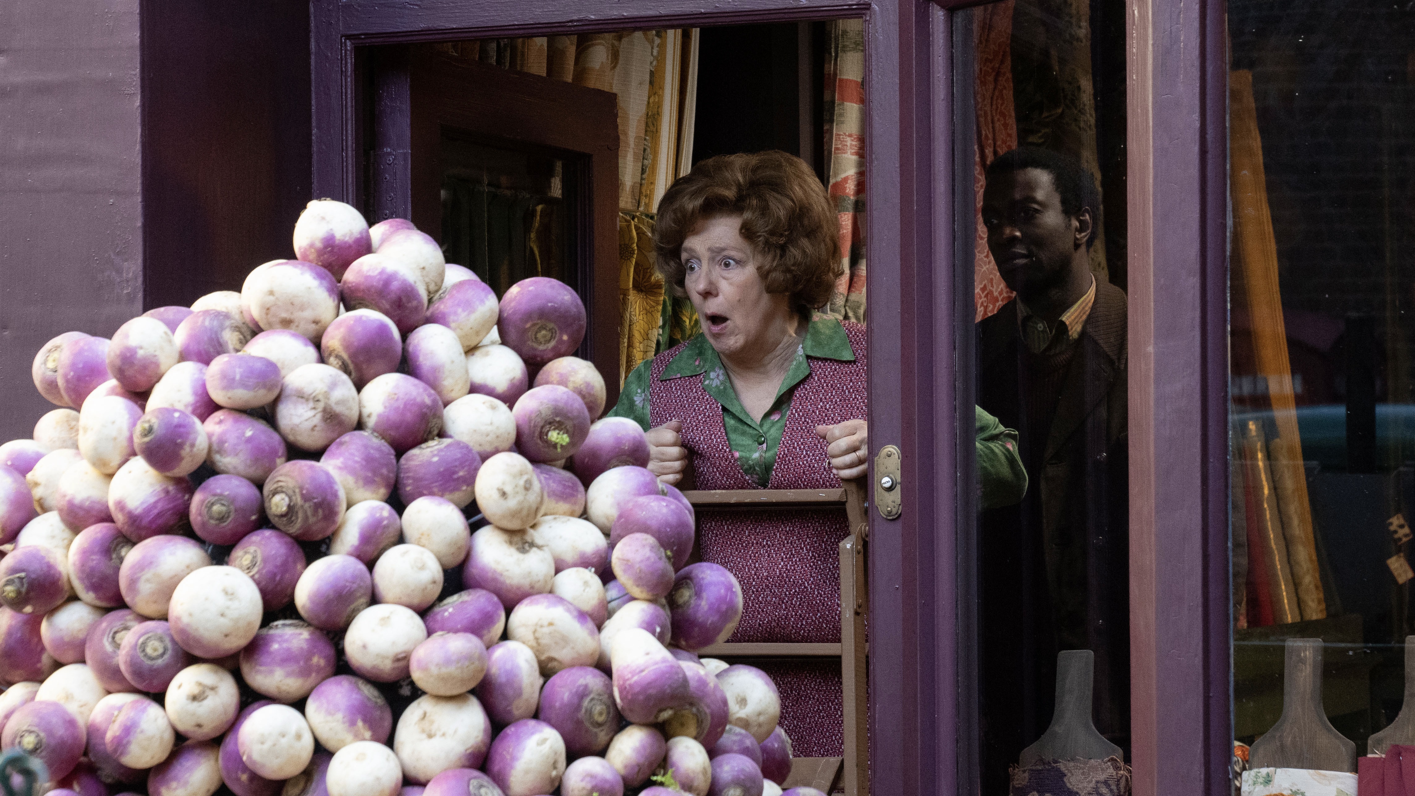 Annabelle Apsion as Violet and Zephryn Taitte as Cyril gape at a huge pile of turnips in Call the Midwife.