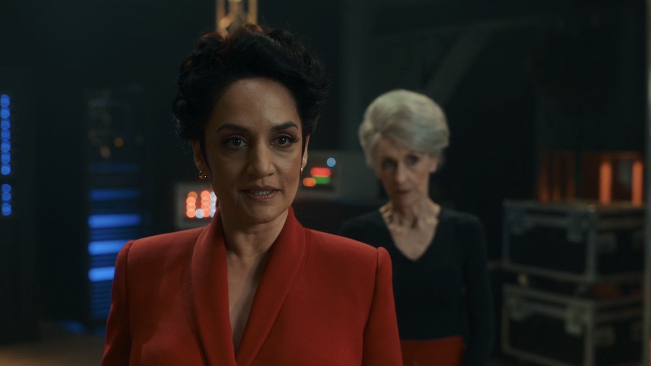 Archie Panjabi's Rani with Anita Dobson's Mrs. Flood standing behind her