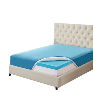 A blue mattress topper on a white bed