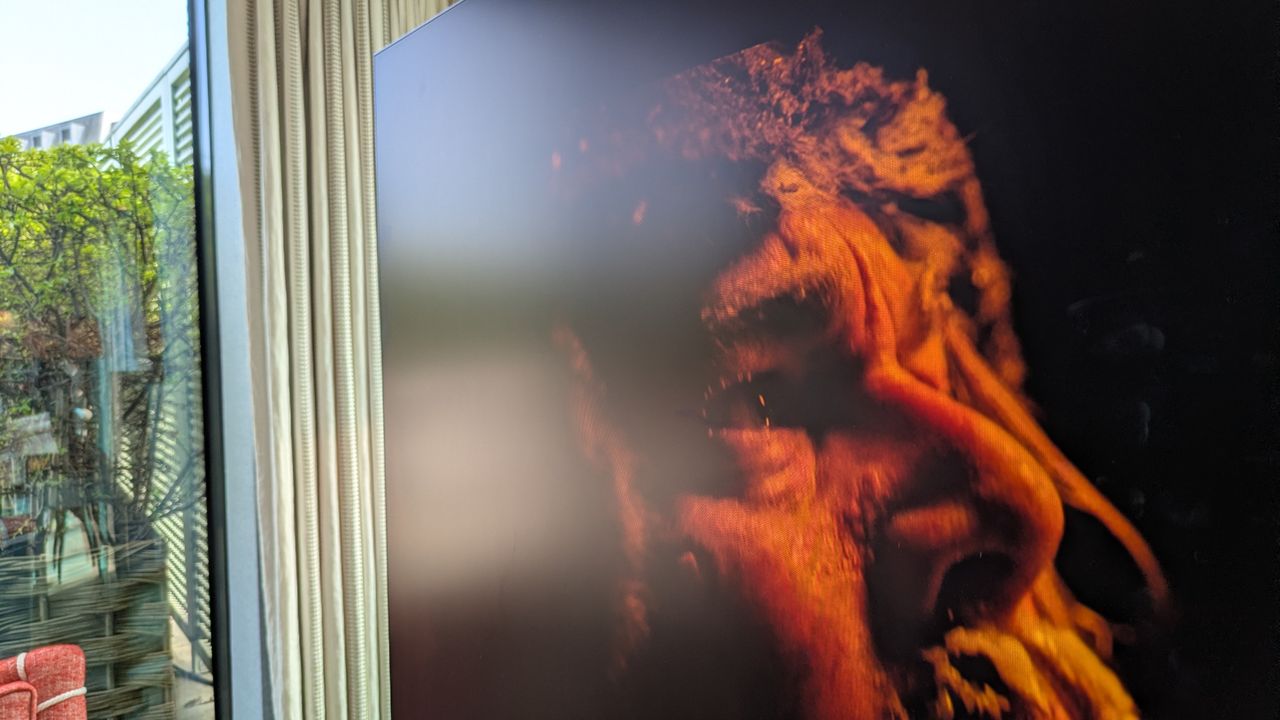 Samsung S90H OLED TV with reflection from glass door on screen, over The Revenant