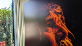 Samsung S90H OLED TV with reflection from glass door on screen, over The Revenant