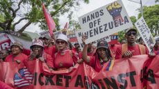 Demonstrators carrying banners gather in front of the United States Embassy to protest U.S. actions in Venezuela, including the detention of President Nicolas Maduro and the U.S. military intervention, on January 08, 2026 in Pretoria, the capital of South Africa