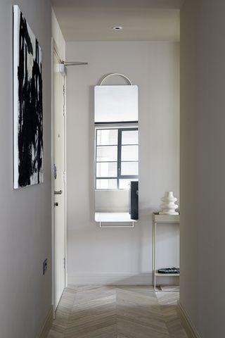 grey entryway with modern mirror