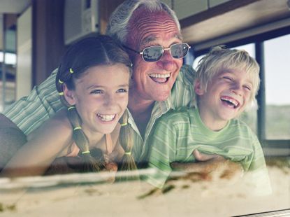 A grandfather enjoys his RV with two of his grandchildren