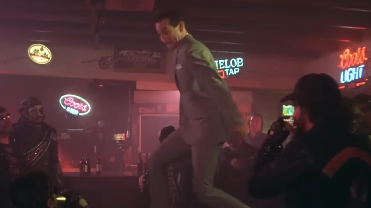 Pee-Wee Herman on top of a bar doing his famous dance