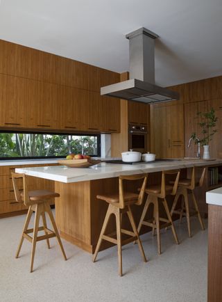kitchen with wood cabinet and island and central ventilation