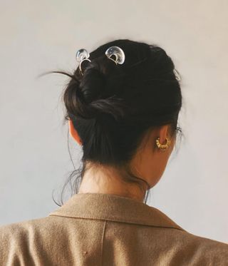 back of woman's head with jewellery in